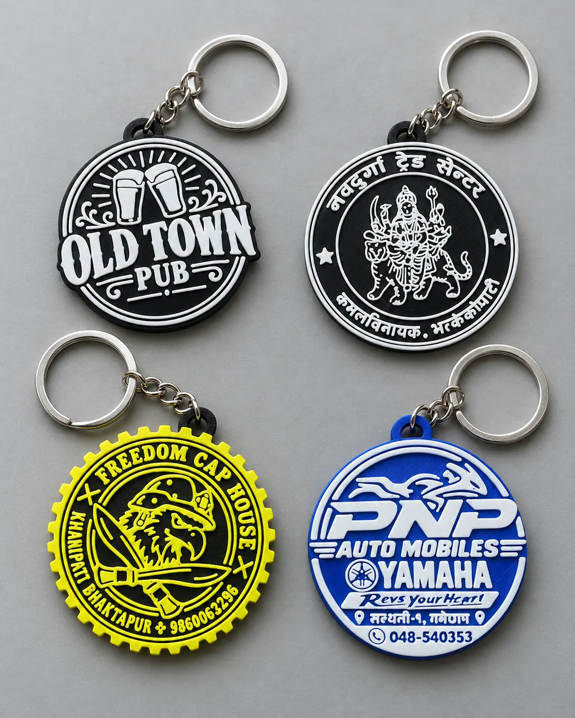 Round company logo keyrings in black, blue, and yellow
