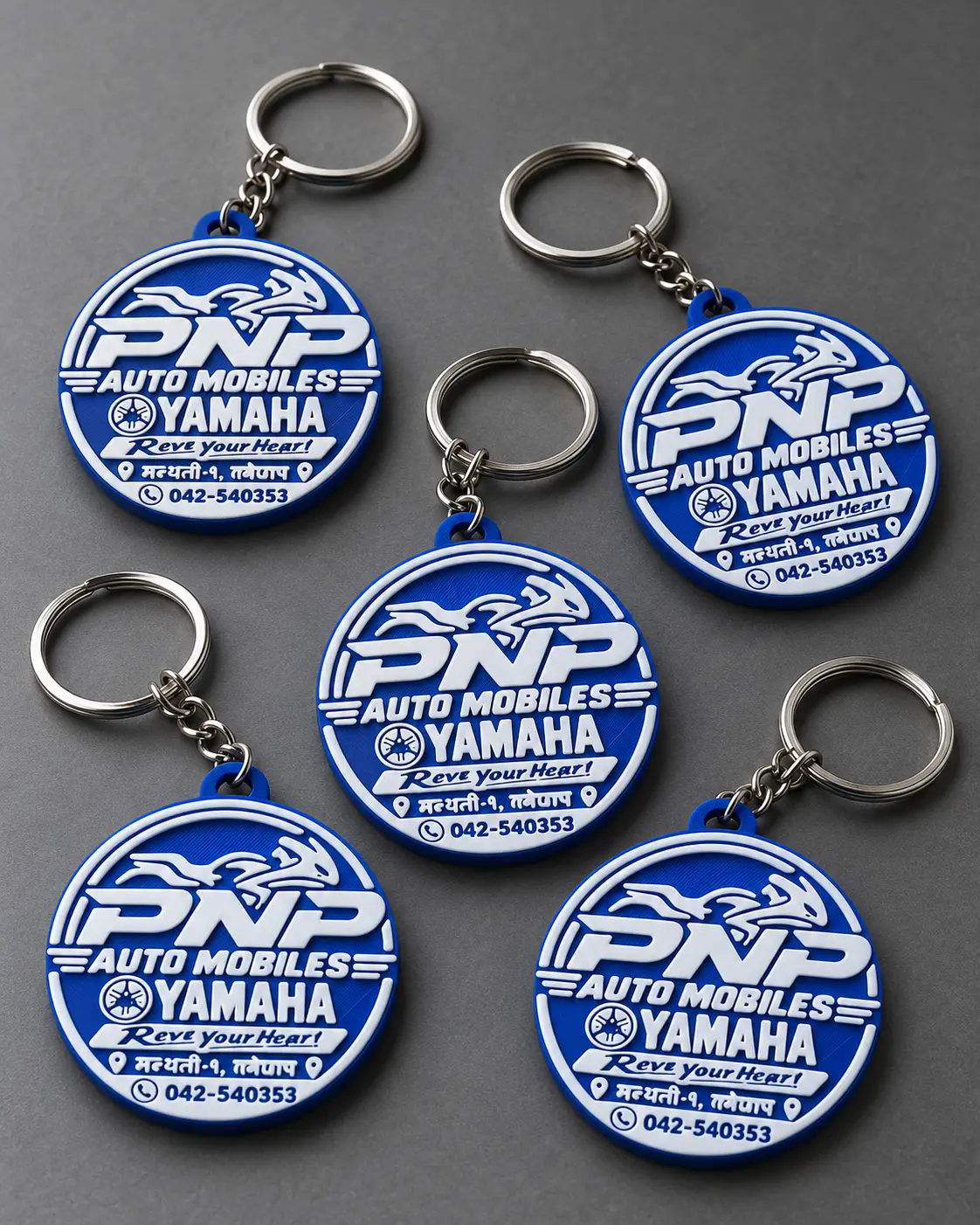A group of blue round automobile logo keyrings with white lettering
