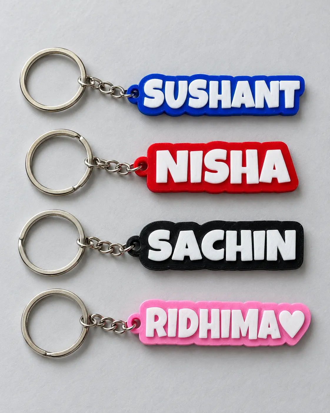 Sushant, Nisha, Sachin, and Ridhima name keyrings with contrasting coloured outlines
